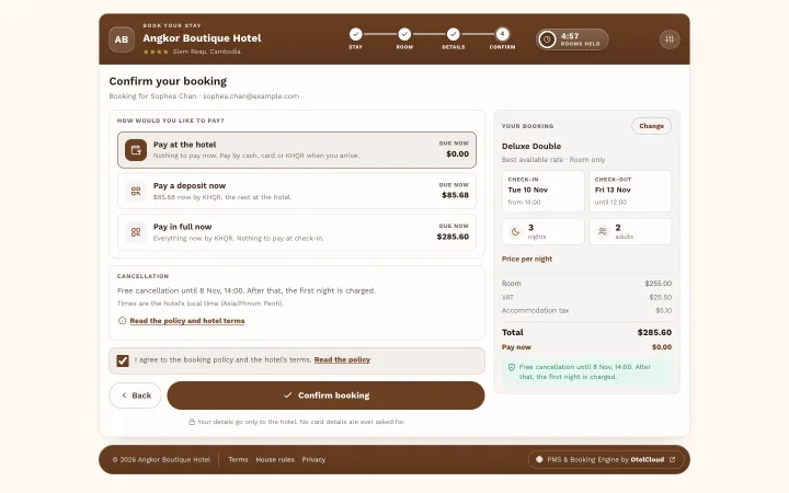 The confirm step: pay at the hotel, a deposit or in full by KHQR, the cancellation policy and a Confirm booking button